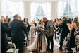 Bride and groom kiss at the end of the aisle