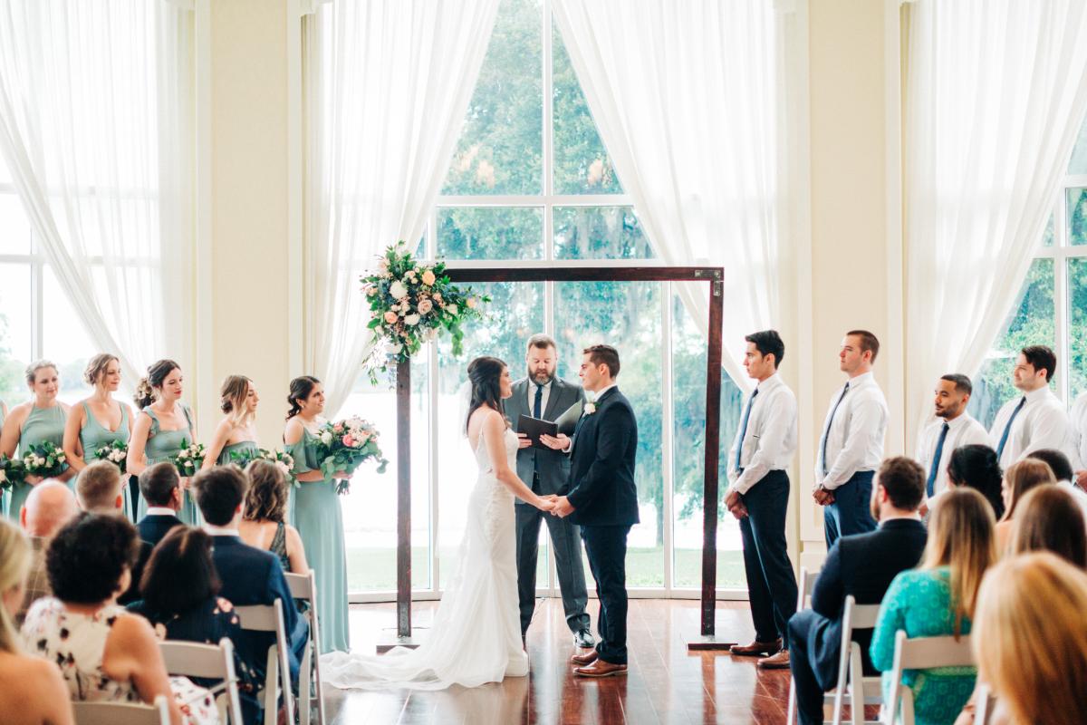 Indoor wedding ceremony in front of a large window
