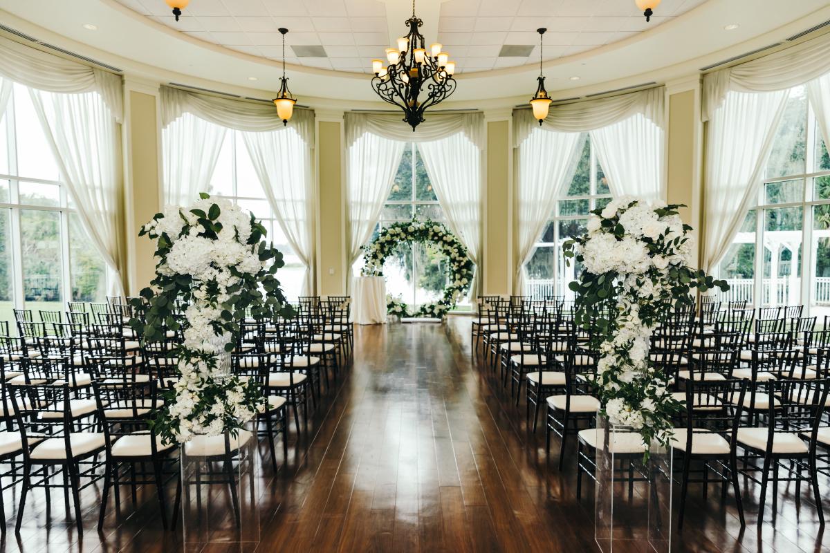 Indoor wedding ceremony with large flower ring