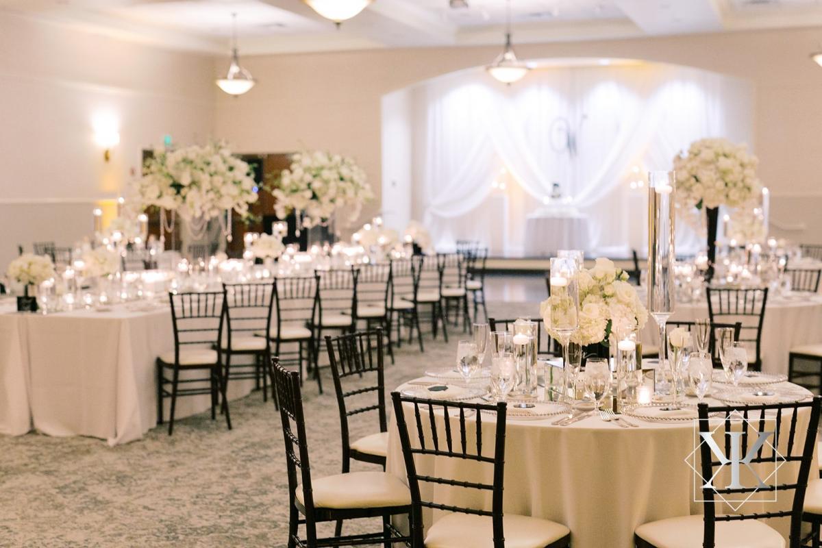 Mix of long and round tables with tall and short floral arrangements