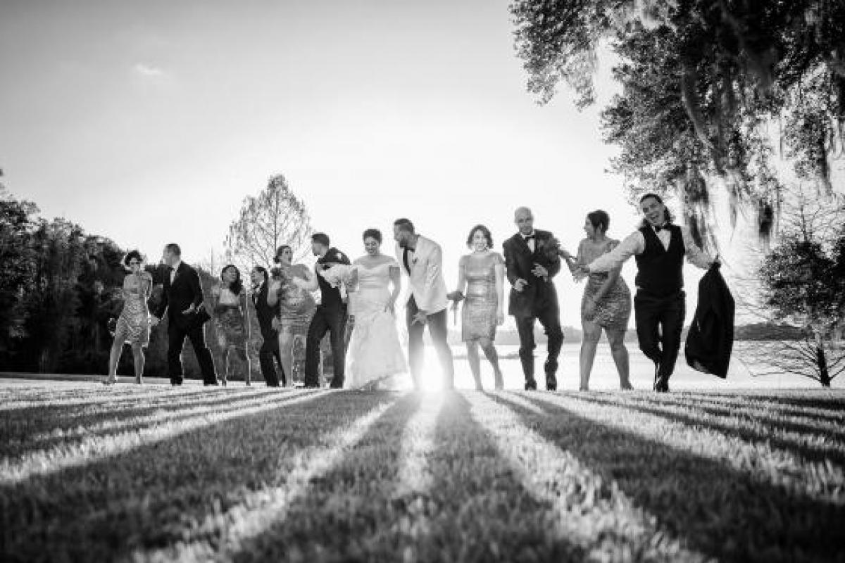 Black and white photo of bride and groom with bridal party